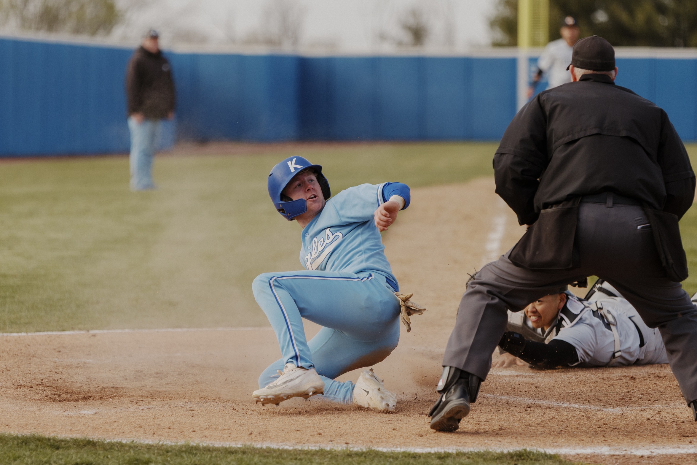 Baseball player sliding into home plate