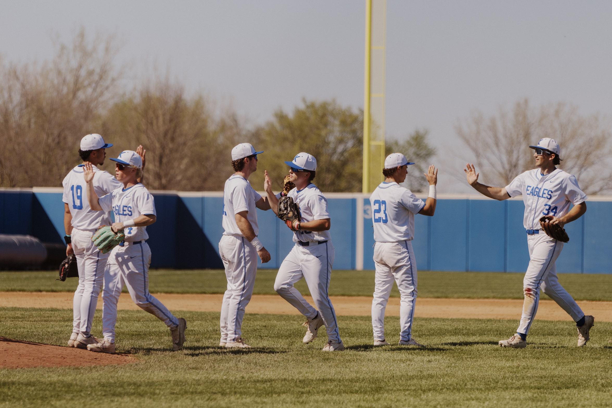 Kirkwood Baseball players high fiving after a game